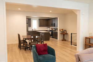 Living area featuring light wood-style flooring and recessed lighting