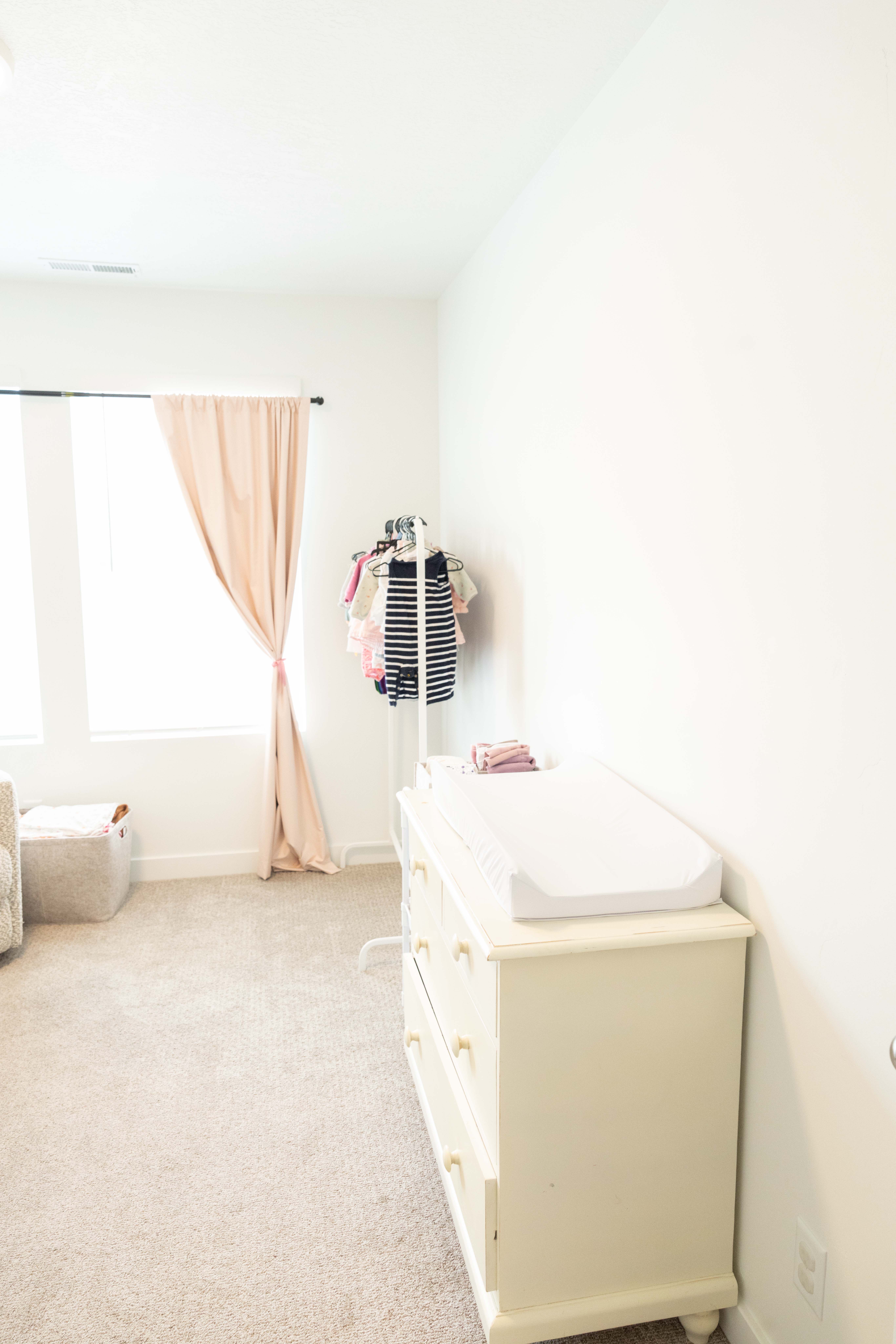 Bedroom featuring light carpet and baseboards