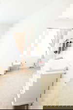 Bedroom featuring light carpet and baseboards