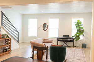 Living area with light wood-type flooring, recessed lighting, and healthy amount of natural light