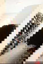 Walk in closet featuring light colored carpet