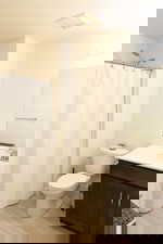 Bathroom featuring vanity, curtained shower, light wood-style flooring, and a textured ceiling