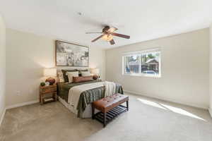 Bedroom featuring light colored carpet and ceiling fan