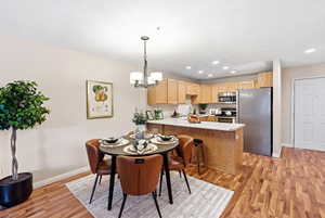 Dining room featuring light wood-type flooring and hanging lights