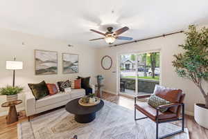 Living area with light wood-type flooring and ceiling fan