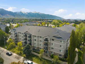 Aerial view of a mountainous background and apartment complex / building