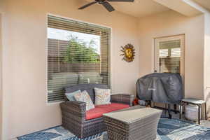 View of patio with grilling area, a ceiling fan, and an outdoor living space