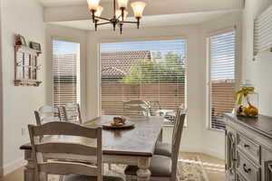 Dining room featuring hanging lights and baseboards