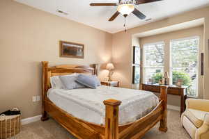 Bedroom featuring light colored carpet and ceiling fan