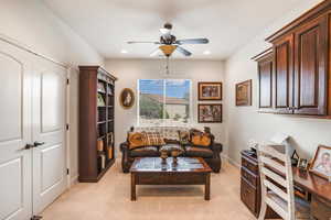 Living room featuring a ceiling fan, light carpet, and recessed lighting
