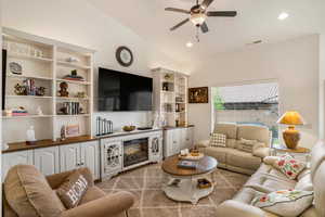 Living area featuring ceiling fan, vaulted ceiling, and recessed lighting