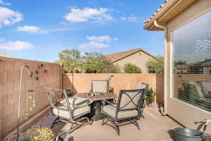 Fenced backyard with a patio area and a fire pit