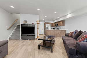 Living area featuring wood tiled floors and recessed lighting