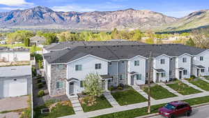 View of front of house with stone siding, a mountain view, and a residential view