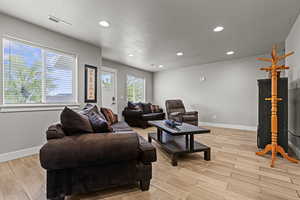 Living room with recessed lighting, wood tiled floors, and a textured ceiling