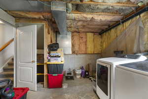Unfinished below grade area with stairway and separate washer and dryer