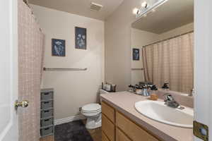 Full bath with vanity, a shower with curtain, and light tile patterned floors