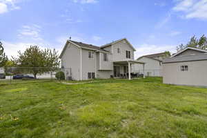 Rear view of property featuring a patio and an outdoor structure