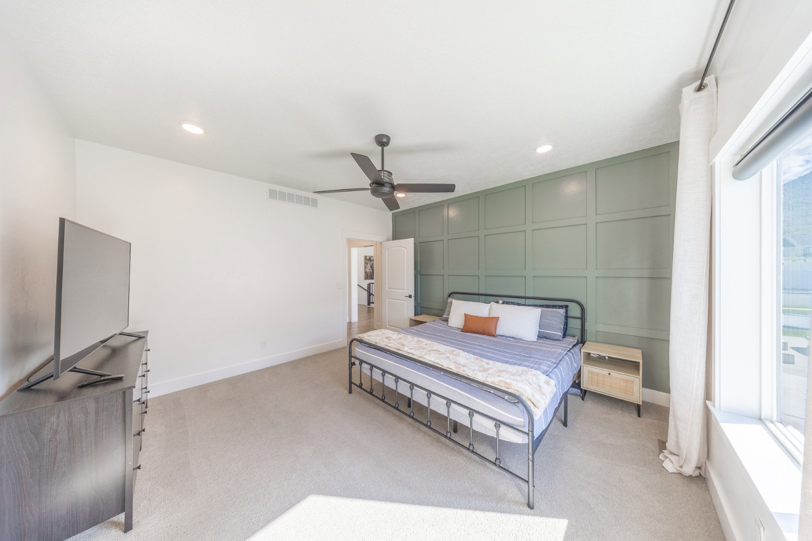 Bedroom with a decorative wall, a ceiling fan, light colored carpet, recessed lighting, and an accent wall
