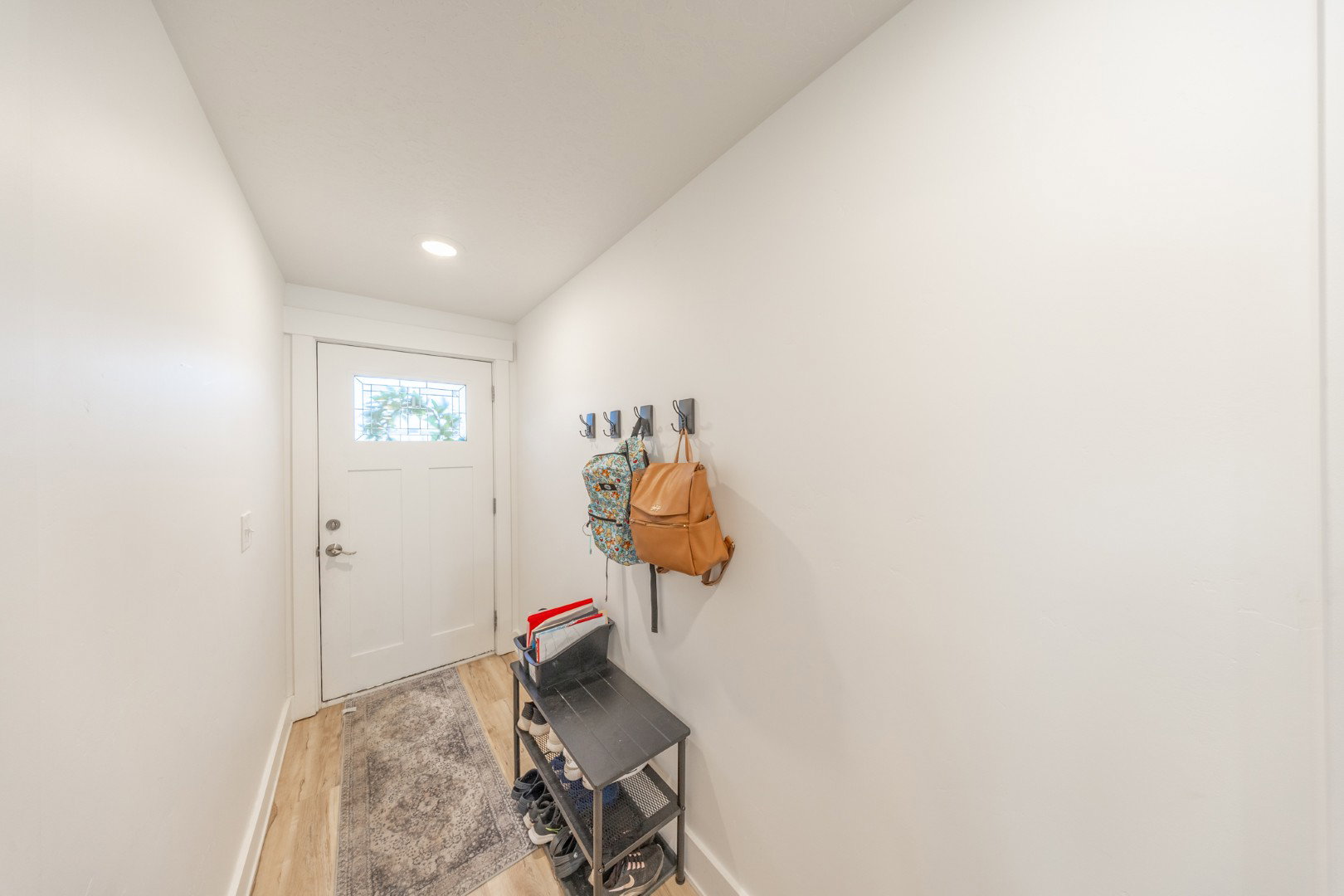 Doorway featuring wood finished floors and recessed lighting