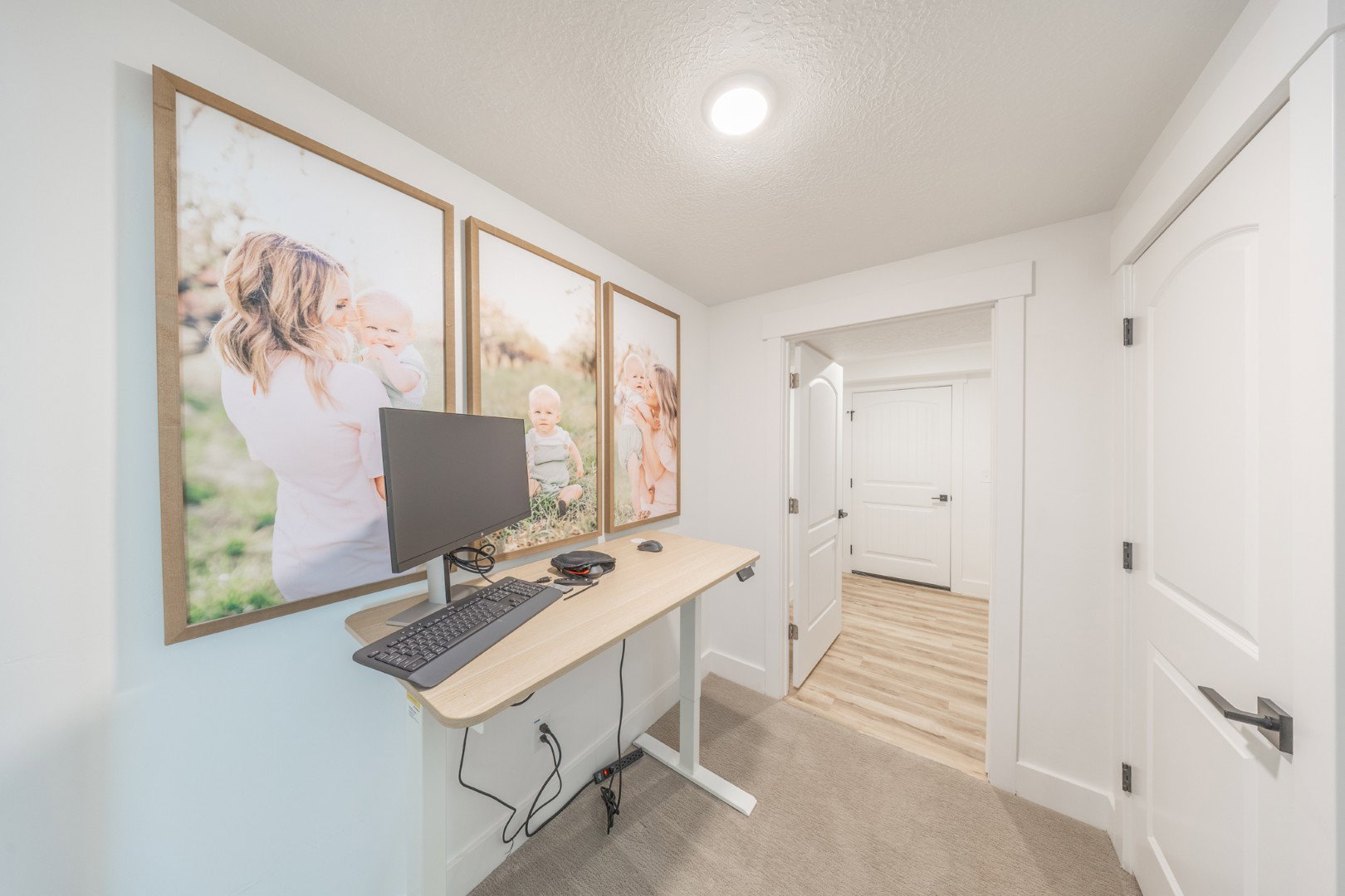 Office space with light carpet and a textured ceiling