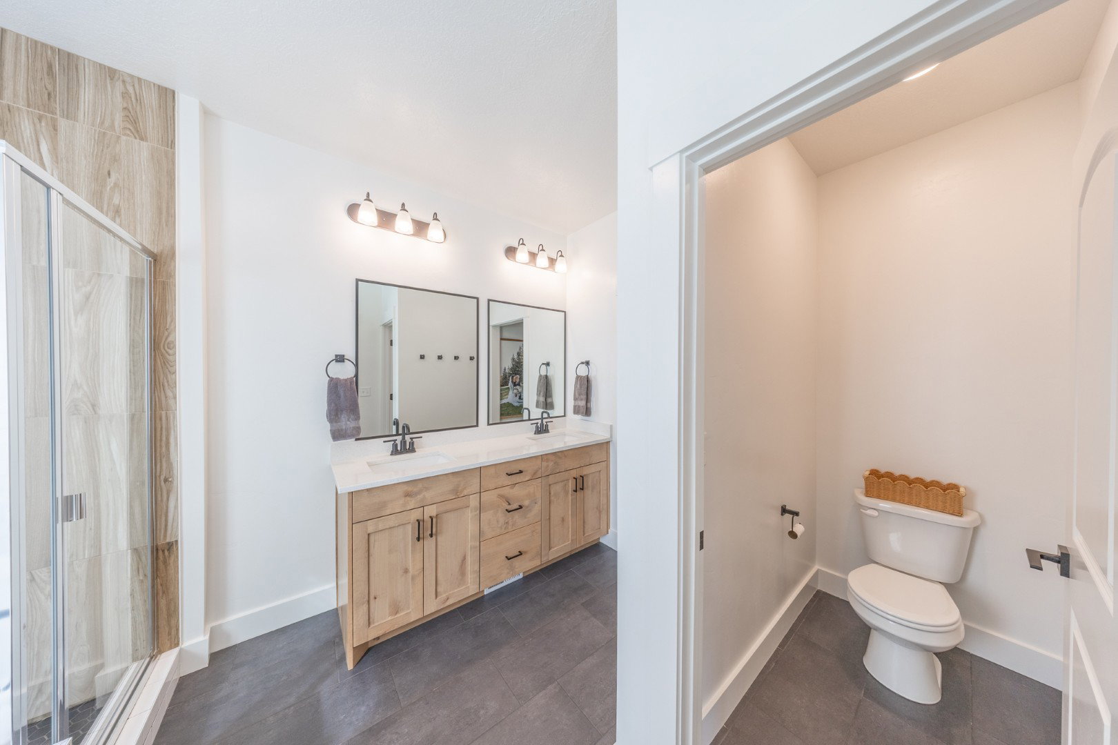 Bathroom featuring double vanity and a stall shower