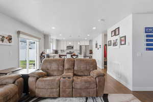 Living room featuring dark wood-style floors and recessed lighting