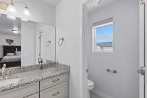 Bathroom featuring vanity and connected bathroom