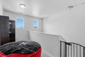Carpeted bedroom featuring a textured ceiling