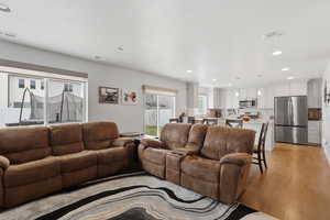 Living room featuring recessed lighting and light wood-type flooring