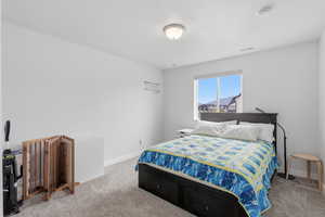 Bedroom featuring carpet floors and baseboards