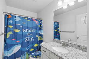 Bathroom featuring vanity and a shower with curtain