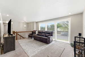 Carpeted living room featuring recessed lighting