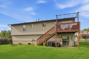 Back of house with stairs and a wooden deck