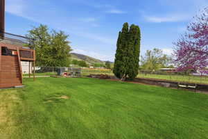 Fenced backyard with a mountain view