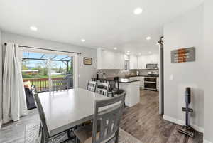 Dining room featuring dark wood-style flooring and recessed lighting