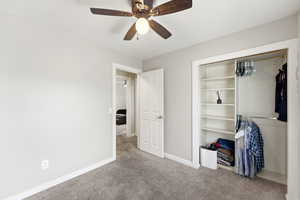 Unfurnished bedroom featuring carpet flooring, a ceiling fan, and a closet