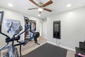 Workout area with recessed lighting, light carpet, and ceiling fan