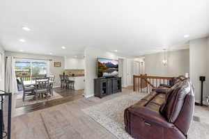 Living room featuring light colored carpet and hanging lights