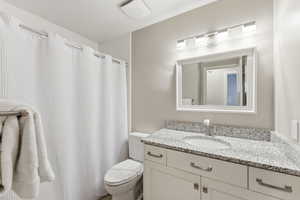 Bathroom featuring vanity and curtained shower