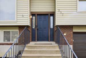 Entrance to property featuring brick siding
