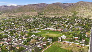Aerial view of residential area featuring property parcel outlined and a mountain backdrop