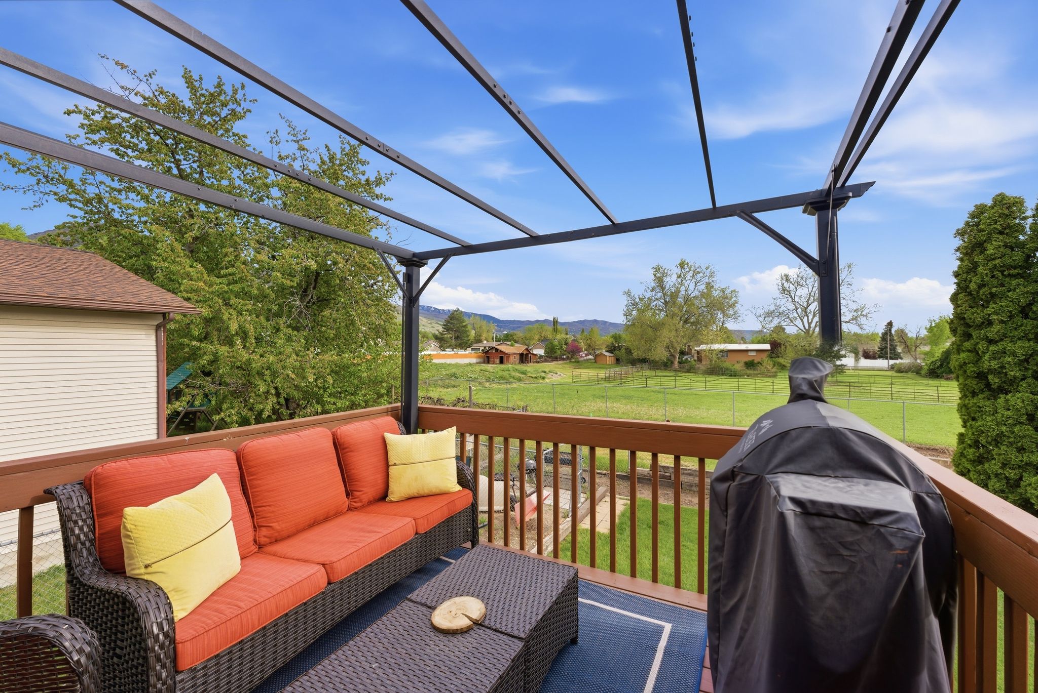 Wooden deck featuring a yard, area for grilling, an outdoor living space, and a mountain view