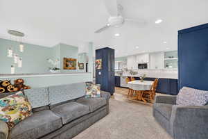 Living room with ceiling fan and recessed lighting
