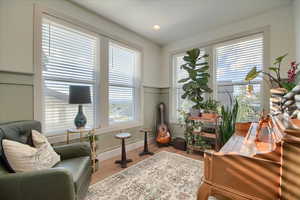 Sitting room with light wood-type flooring and baseboards