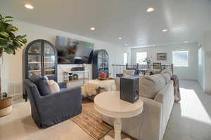 Upstairs living area with light carpet and recessed lighting