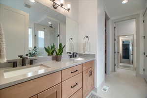 Master bathroom with a shower stall, double vanity, and recessed lighting