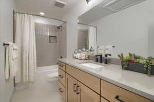 Full bath with vanity, shower / tub combo with curtain, and recessed lighting