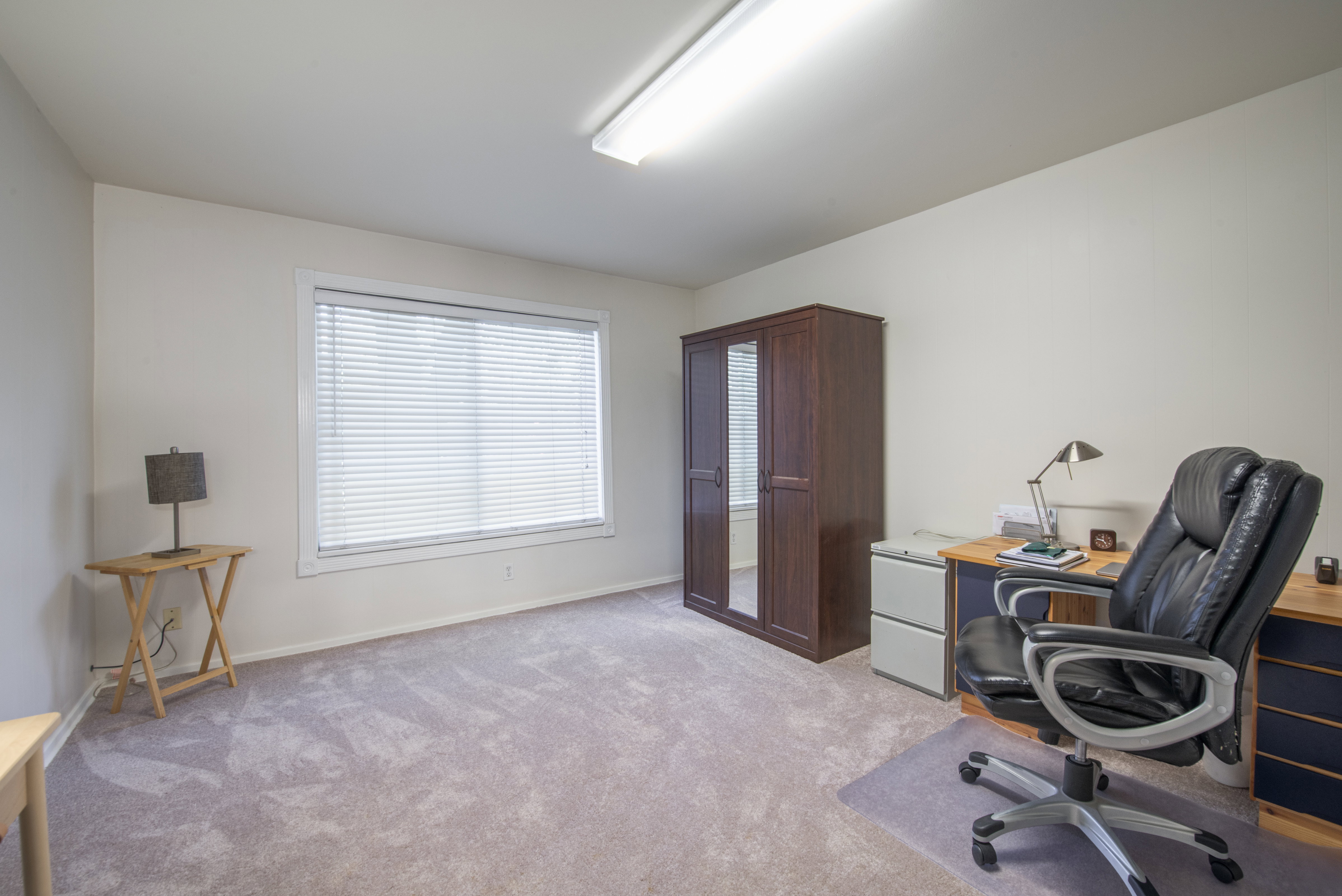 Office area with light colored carpet and baseboards