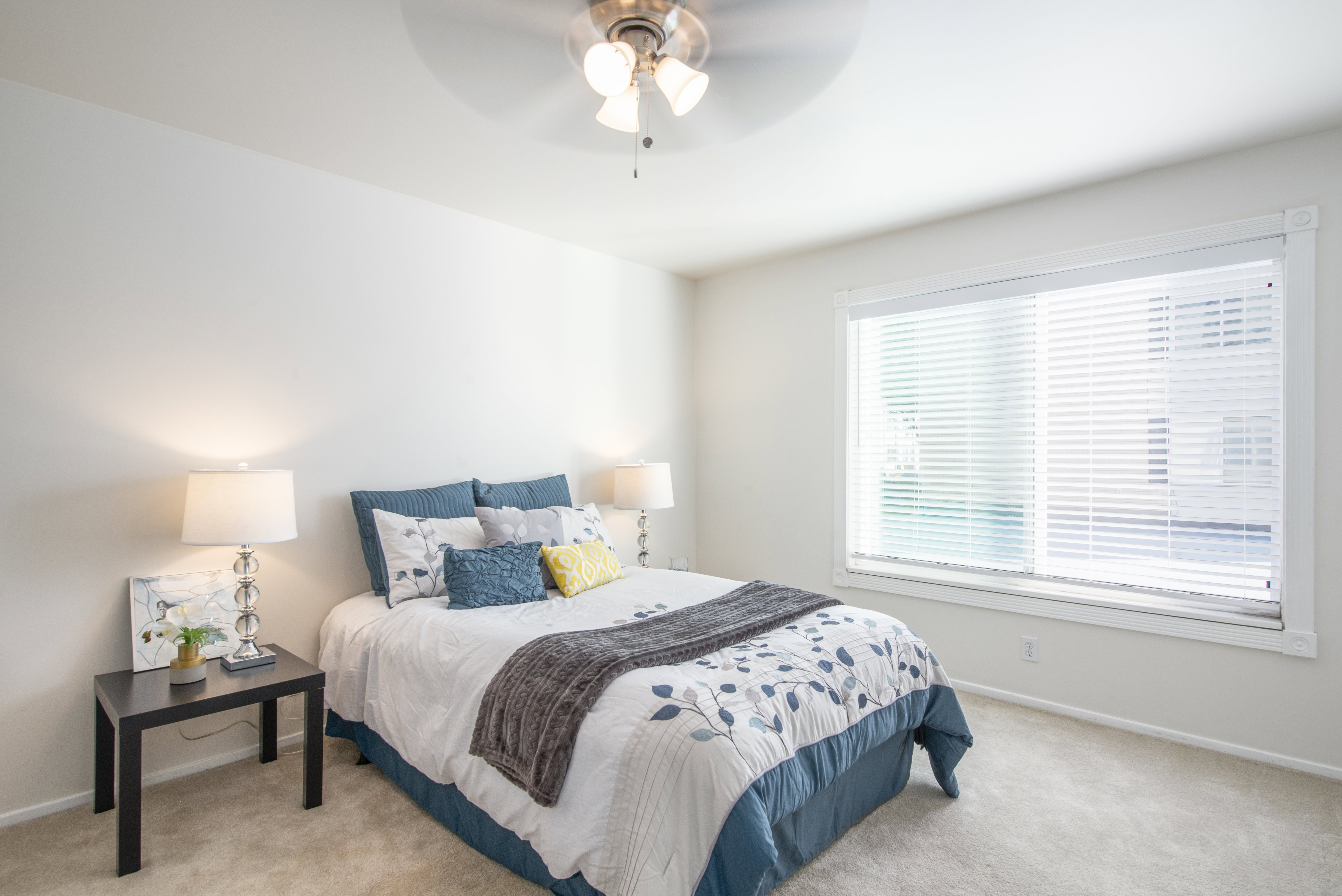 Bedroom with light carpet and ceiling fan